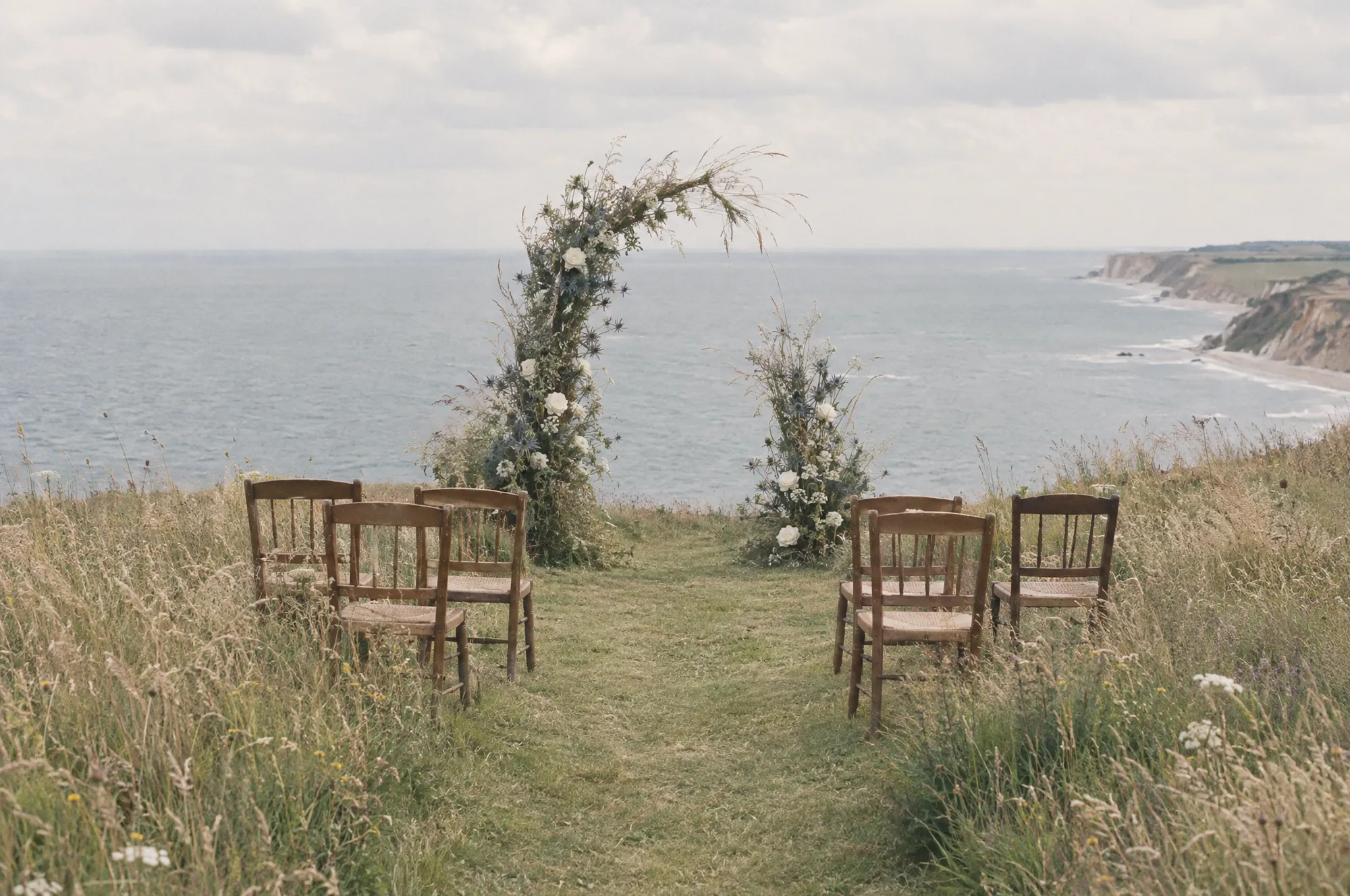 Chairs and a wild flower arch on the clifftop lawn above the North Sea